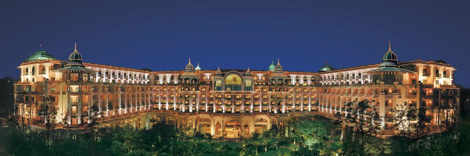 Pool and gardens at The Leela Palace Bengaluru