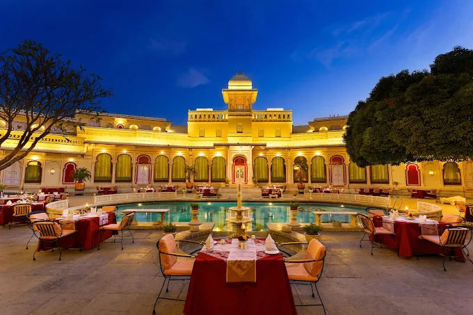 High-end wedding venue in Udaipur with elegant drapes, chandeliers, and floral styling