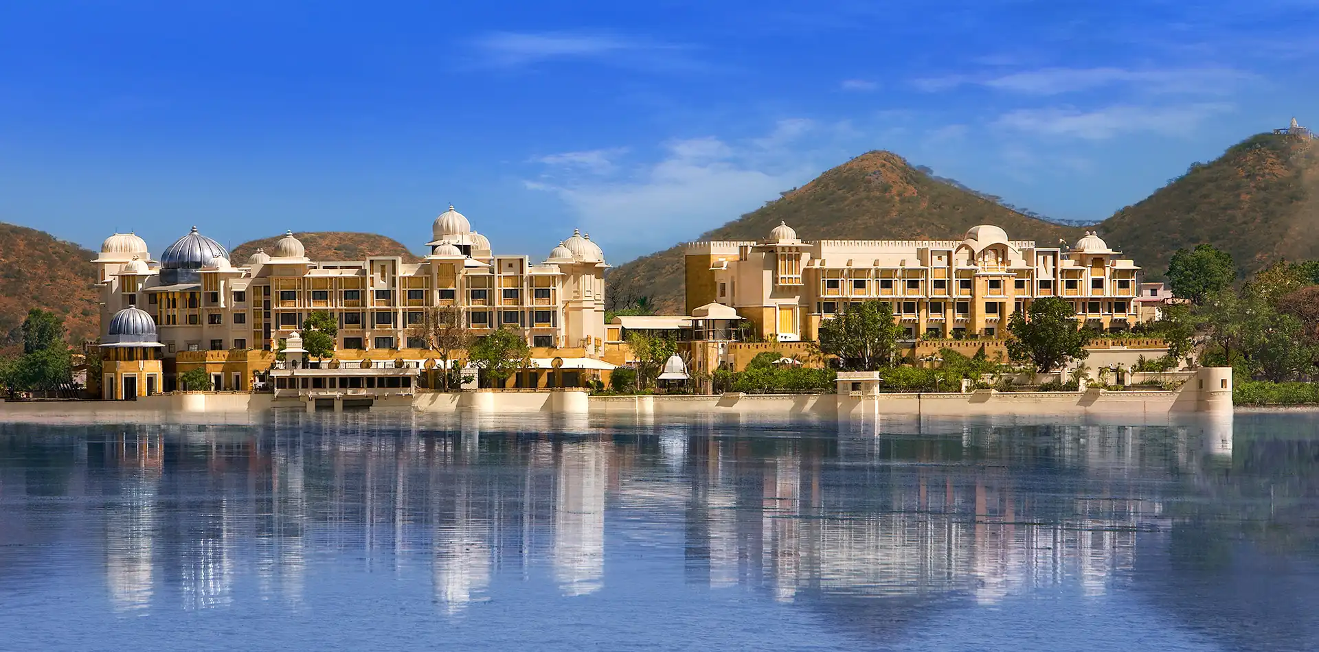 Lakeside pool and palace architecture at The Leela Palace Udaipur